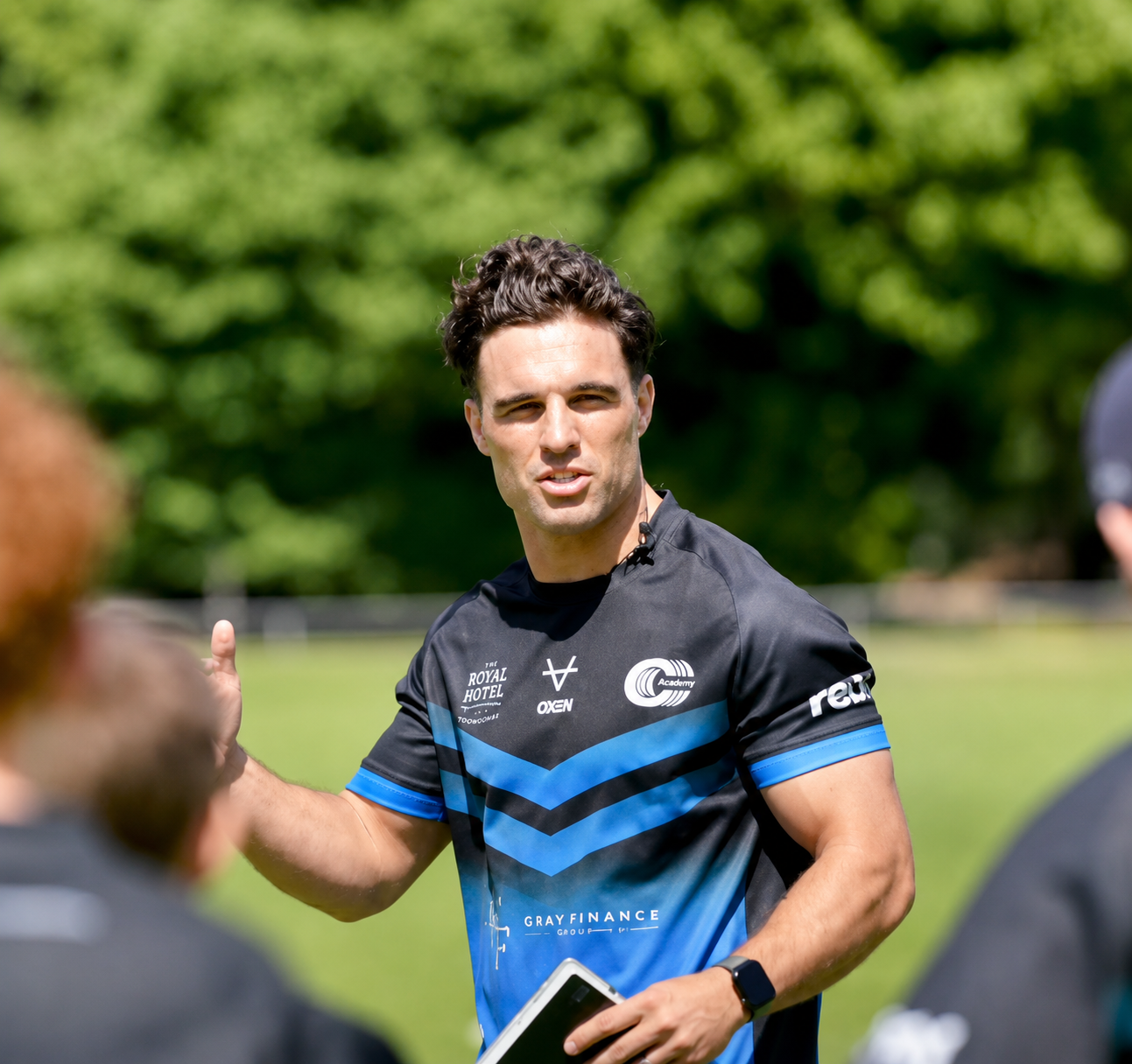 Brodie Croft in the Triple C Academy kit talking to players during a training session